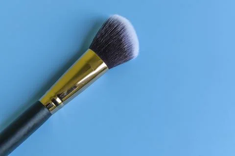 Makeup brush on a blue background Stock Photos