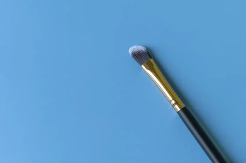 Makeup brush on a blue background Stock Photos