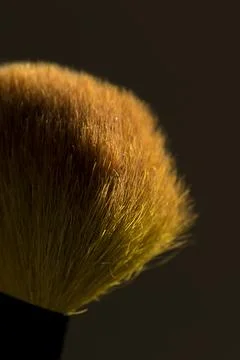 Makeup brush on a dark background with pink pigment Stock Photos