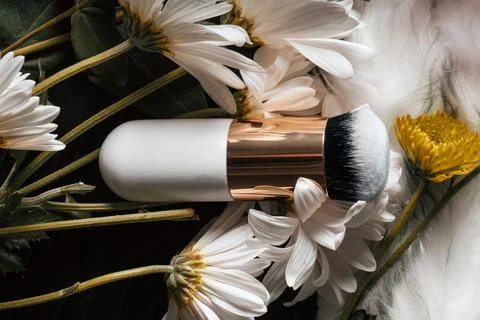 Makeup-brush-in-flowers  Stock Photos