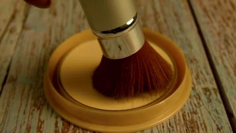 The makeup brush glides over the surface of the compact powder. Makeup concept Stock Footage 262157738