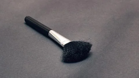 Makeup brush on a gray background closeup Stock Photos