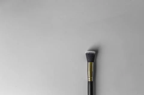 Makeup brush on a grey background Stock Photos