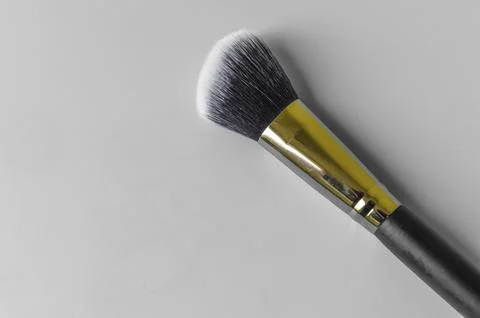 Makeup brush on a grey background Stock Photos