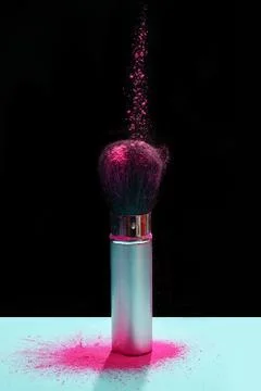 Makeup brush with holi paint Stock Photos
