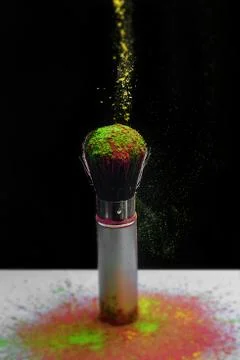 Makeup brush with holi paint Stock Photos