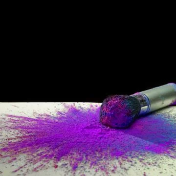 Makeup brush with holi paint Stock Photos