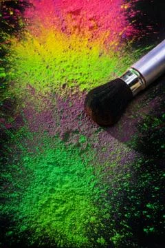 Makeup brush with holi paint Stock Photos