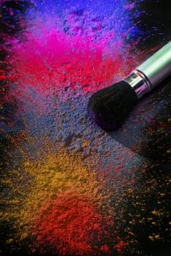 Makeup brush with holi paint Stock Photos