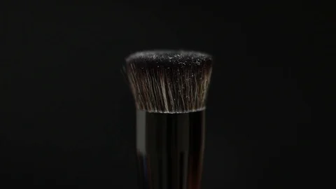 Makeup brush. Makeup brush rotates. Brush on a black background. Stock Footage 128784073