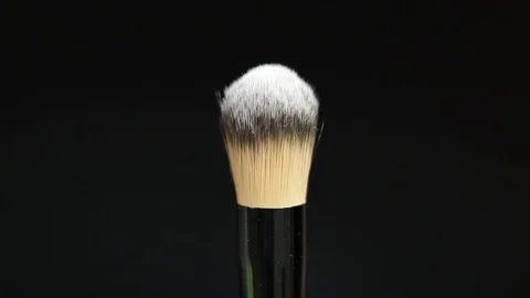 Makeup brush. Makeup brush rotates. Brush on a black background. Stock Footage 128784092