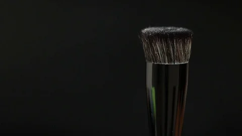Makeup brush. Makeup brush rotates. Brush on a black background. Stock Footage 128784097