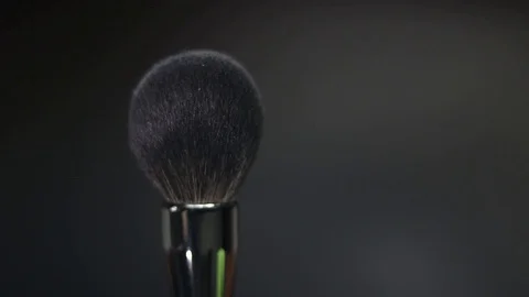 Makeup brush. Makeup brush rotates. Brush on a black background. Stock Footage 128784110