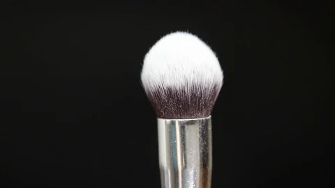 Makeup brush. Makeup brush rotates. Brush on a black background. Stock Footage 128784118