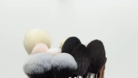Makeup brush. Makeup brush rotates. Brush on a black background. Stock Footage 128784124