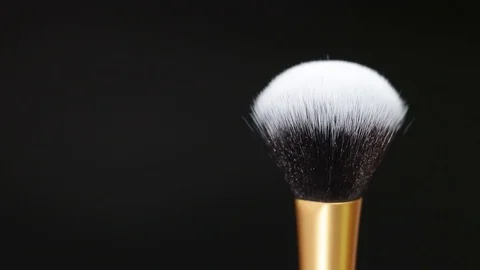 Makeup brush. Makeup brush rotates. Brush on a black background. Stock Footage 128784204