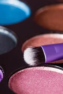Makeup brush with makeup palette in the background Stock Photos