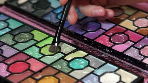 Makeup brush moving over multicolor eye shadows palette Stock Footage 39368237