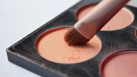 Makeup brush picks up blush powder from palette for beauty application. Stock Footage 332879857