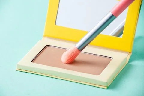 Makeup brush picks eyeshadow in macro. Makeup product Stock Photos