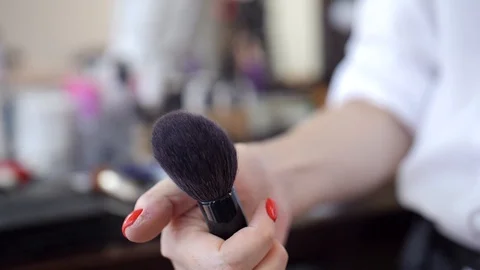 Makeup brush with powder moving,  visagiste use brush with cosmetics slow motion Stock Footage 96230174