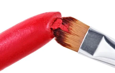 Makeup brush pushed in on red lipstick, isolated on white Stock Photos