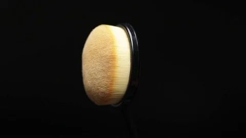 Makeup brush rotates on a black background. Stock Footage 128191132