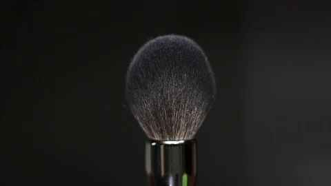 Makeup brush rotates on a black background. Stock Footage 128191149