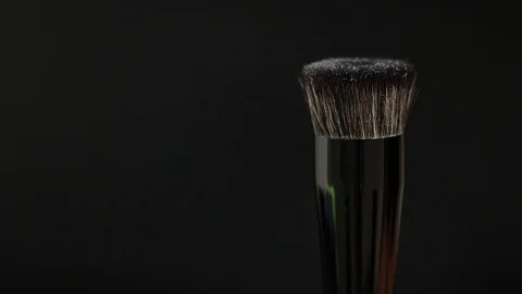 Makeup brush rotates on a black background. Stock Footage 128191203