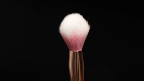 Makeup brush rotates on a black background. Stock Footage 128191218