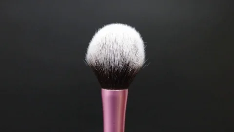 Makeup brush rotates on a black background. Stock Footage 128191248