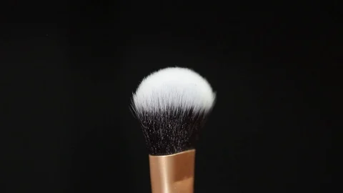 Makeup brush rotates on a black background. Stock Footage 128191264