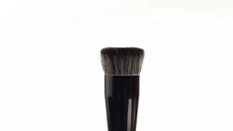 Makeup brush rotates on a white background. Makeup brush. Close-up. Stock Footage 128191308