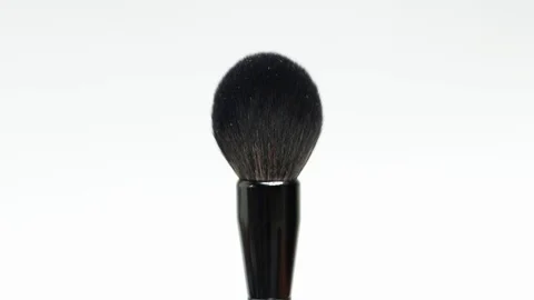 Makeup brush rotates on a white background. Makeup brush. Close-up. Stock Footage 128191366