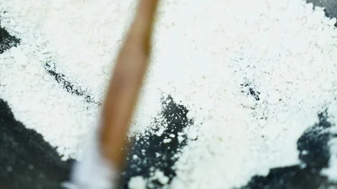Makeup brush sweeping through white rice powder, Close view of a makeup bru.. Video stock 346466665