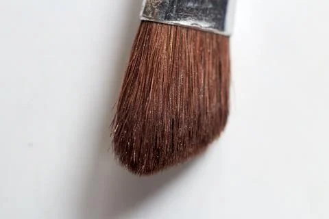 A makeup brush on a white background helps to apply makeup on the face. Stock Photos