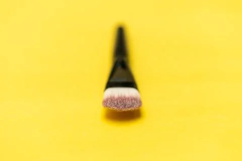Makeup brush with yellow background Stock Photos