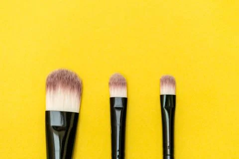 Makeup brush with yellow background Stock Photos