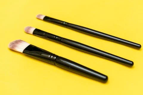 Makeup brush with yellow background Stock Photos