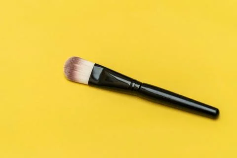Makeup brush with yellow background Stock Photos