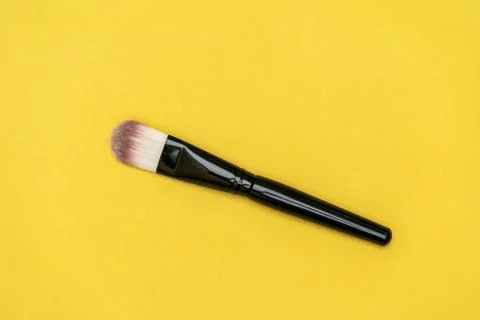 Makeup brush with yellow background Stock Photos