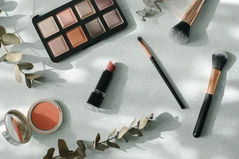 Makeup brushes and cosmetics on light background. Beauty, fashion concept. Stock Photos