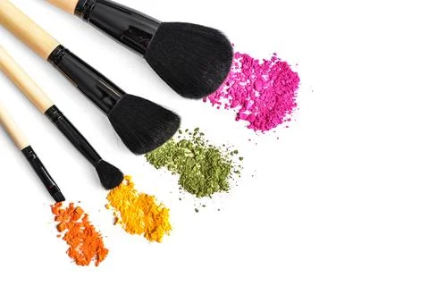 Makeup brushes and crushed eyeshadow Stock Photos