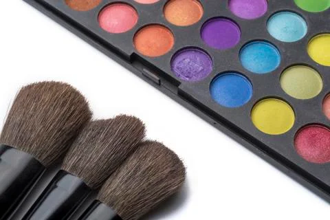 Makeup brushes and eye shadow, on white isolated background. Stock Photos
