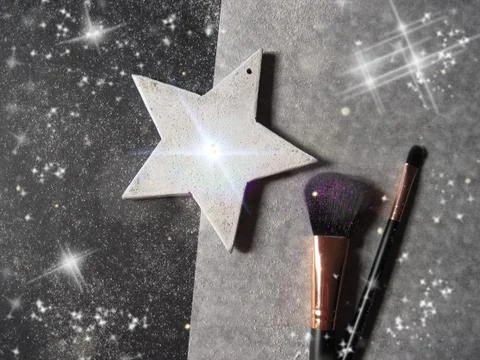 Makeup brushes and white star on a glitter black and white background Stock Photos