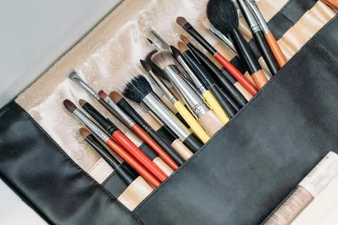 Makeup brushes are in a drawer at the makeup artist's workplace. close-up Stock Photos