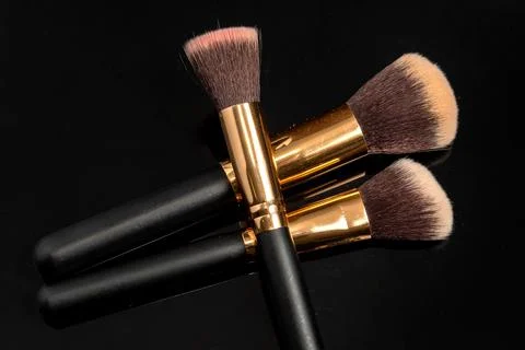 Makeup brushes on black background. Close up of makeup brushes set Stock Photos