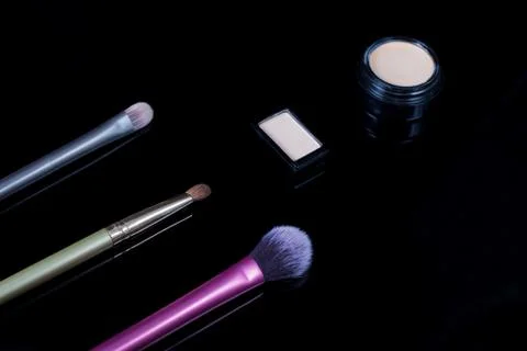 Makeup brushes on black background. Cosmetics, fashion, beauty, glamour. Acce Stock Photos