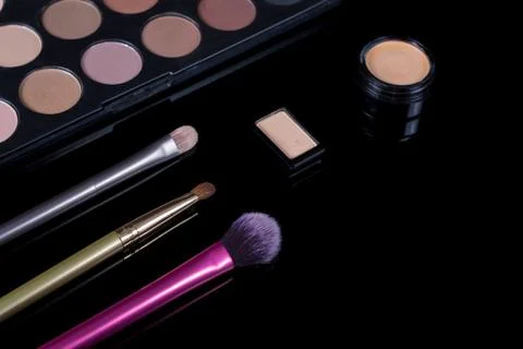 Makeup brushes on black background. Cosmetics, fashion, beauty, glamour. Acce Stock Photos