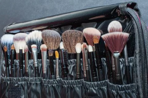 Makeup brushes on a black background, with a place to insert text, Stock Photos